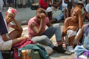 New Orleans residents wait for a bus out of the city following Hurricane Katrina